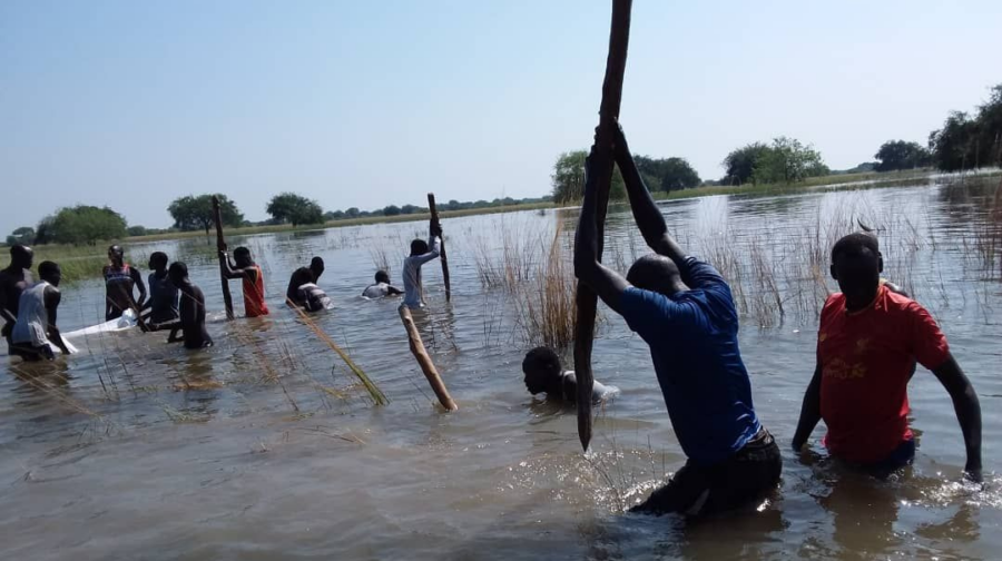 Jugendliche bei der Reapratur durchbrochener Stellen eines Deiches im Südsudan